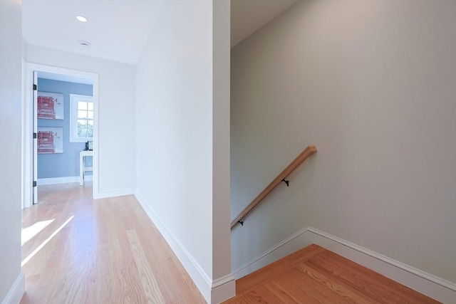 corridor with light hardwood / wood-style flooring