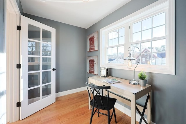 home office with light hardwood / wood-style floors