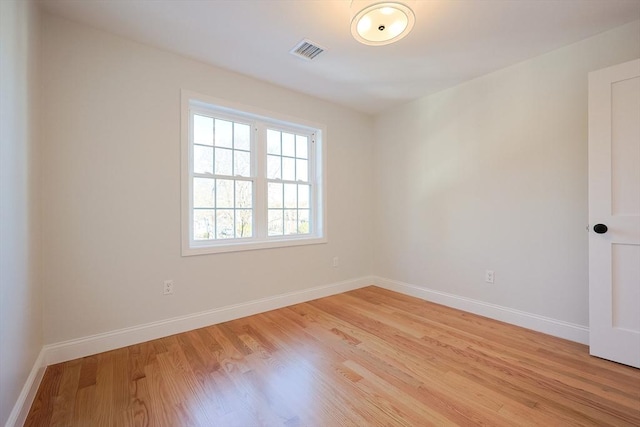 spare room featuring light hardwood / wood-style flooring