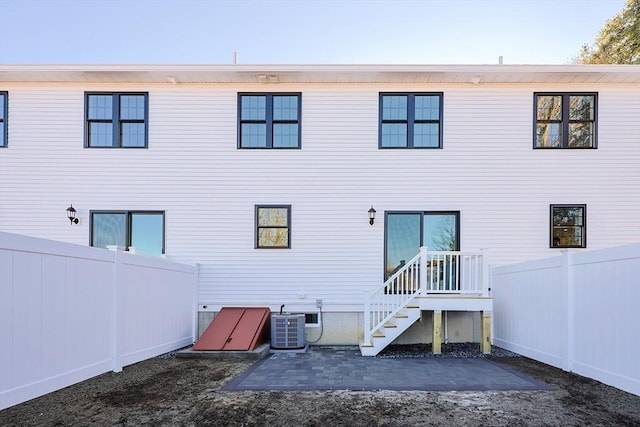 back of property featuring central AC unit and a patio