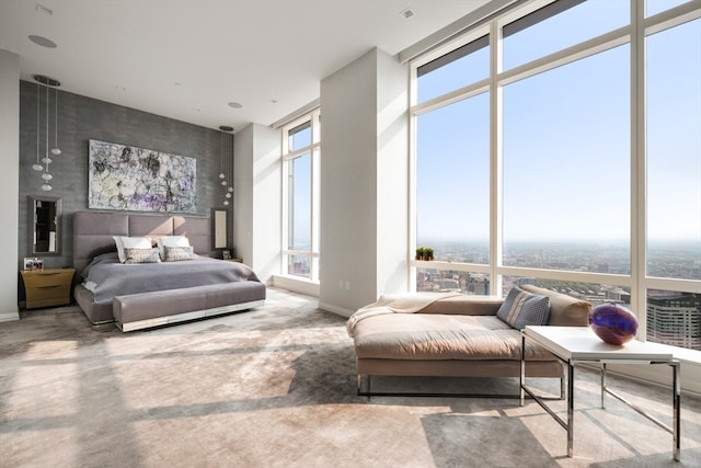 bedroom with concrete flooring and a wall of windows