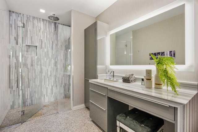 bathroom with vanity and a tile shower