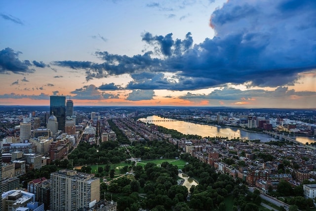 aerial view at dusk featuring a water view