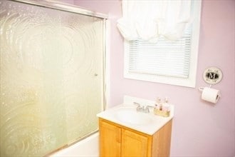 bathroom featuring vanity and combined bath / shower with glass door