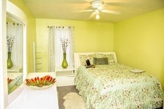 bedroom featuring dark colored carpet and ceiling fan