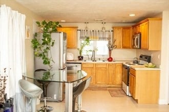 kitchen featuring sink, light tile patterned flooring, and stainless steel appliances