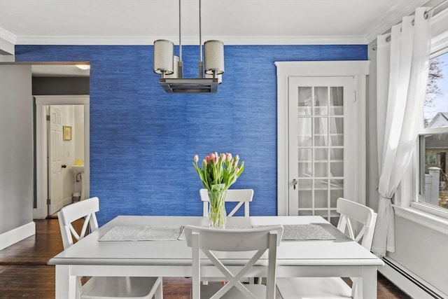 dining room with ornamental molding, a baseboard radiator, an accent wall, and wallpapered walls