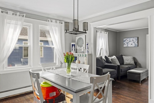 dining space featuring dark wood-style floors, ornamental molding, and baseboard heating