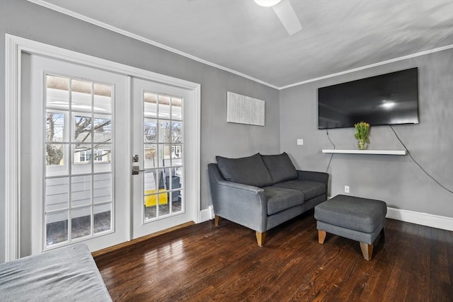 sitting room with ornamental molding, baseboards, hardwood / wood-style floors, and a ceiling fan