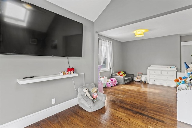 game room with vaulted ceiling and wood finished floors