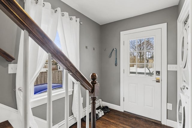 entrance foyer with stairs, baseboards, and dark wood-style flooring