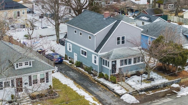 snowy aerial view with a residential view