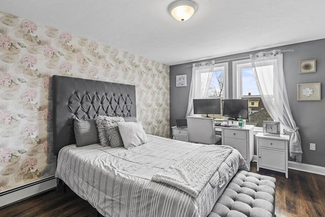 bedroom featuring a baseboard heating unit, dark wood-style flooring, baseboards, and wallpapered walls