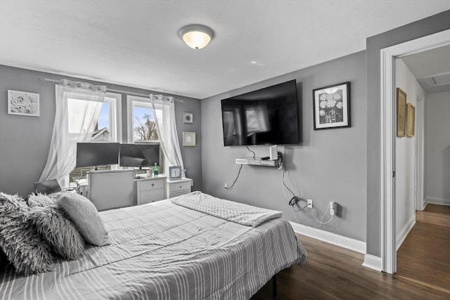 bedroom featuring dark wood-style flooring, visible vents, and baseboards