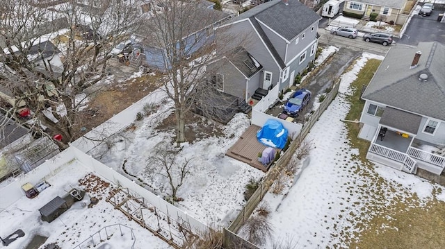 snowy aerial view with a residential view