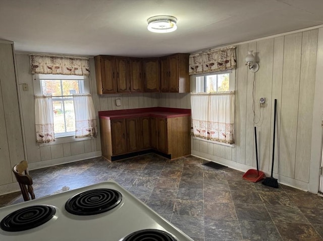 kitchen with wood walls and white range with electric stovetop