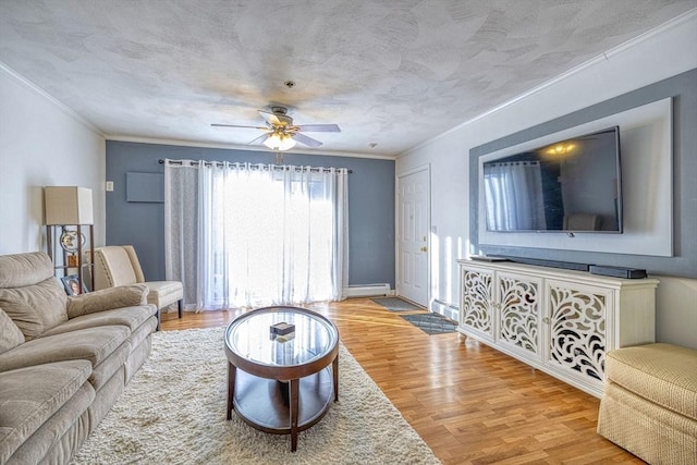 living room with light hardwood / wood-style floors, baseboard heating, ornamental molding, and ceiling fan