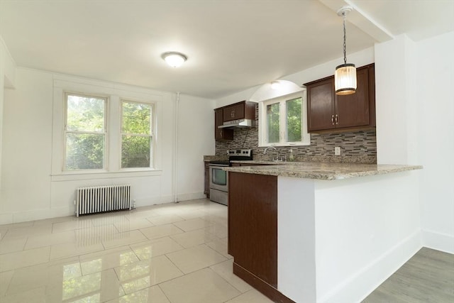 1194 Thorndike St, Palmer, MA 01069 - kitchen featuring radiator, stainless steel range with electric stovetop, under cabinet range hood, dark brown cabinetry, and decorative backsplash