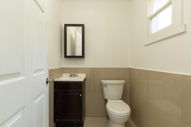 1194 Thorndike St, Palmer, MA 01069 - half bath featuring vanity, a wainscoted wall, tile walls, and tile patterned floors