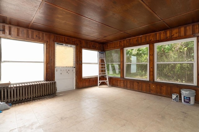 1194 Thorndike St, Palmer, MA 01069 - unfurnished sunroom featuring radiator heating unit, wood ceiling, and wooden walls