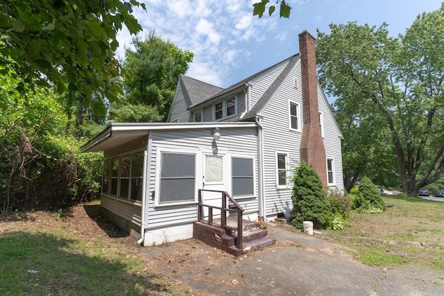 1194 Thorndike St, Palmer, MA 01069 - view of side of property featuring a chimney and roof with shingles
