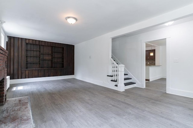 1194 Thorndike St, Palmer, MA 01069 - unfurnished living room with stairway, wood finished floors, and a brick fireplace
