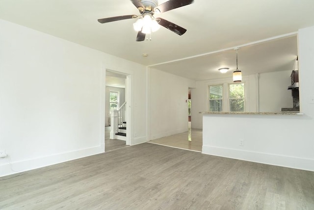 1194 Thorndike St, Palmer, MA 01069 - unfurnished living room featuring light wood-style floors, ceiling fan, and stairway