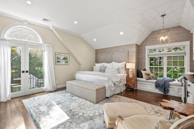 bedroom featuring a notable chandelier, dark hardwood / wood-style flooring, access to exterior, vaulted ceiling, and french doors