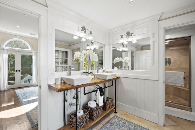 bathroom featuring vanity, ornamental molding, wood-type flooring, and french doors