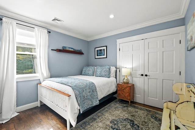 bedroom featuring a closet, ornamental molding, and dark hardwood / wood-style flooring