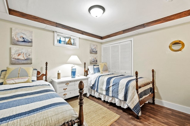 bedroom with a closet and dark hardwood / wood-style flooring