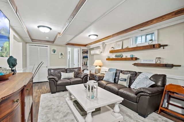 living room featuring built in features and dark hardwood / wood-style flooring