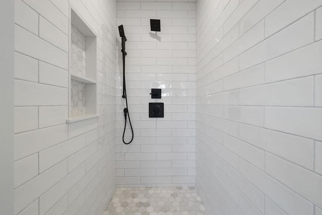 bathroom with tiled shower