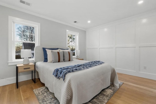 bedroom featuring hardwood / wood-style floors and ornamental molding