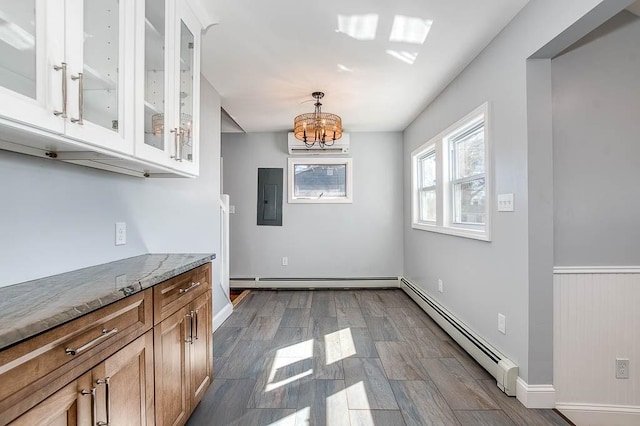 unfurnished dining area featuring a baseboard heating unit, an AC wall unit, electric panel, and a notable chandelier