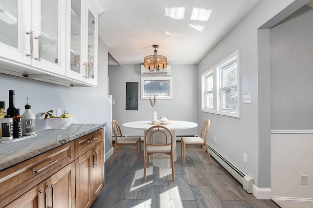 dining area featuring baseboard heating, electric panel, wood tiled floor, a wall mounted air conditioner, and an inviting chandelier