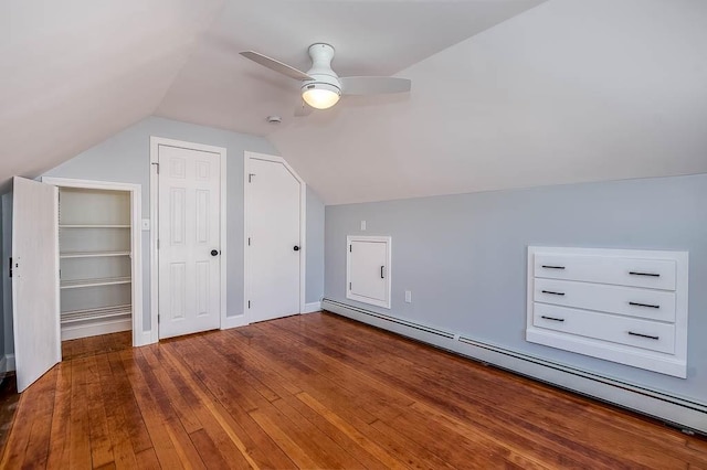 bonus room featuring lofted ceiling, baseboard heating, wood-type flooring, and a ceiling fan