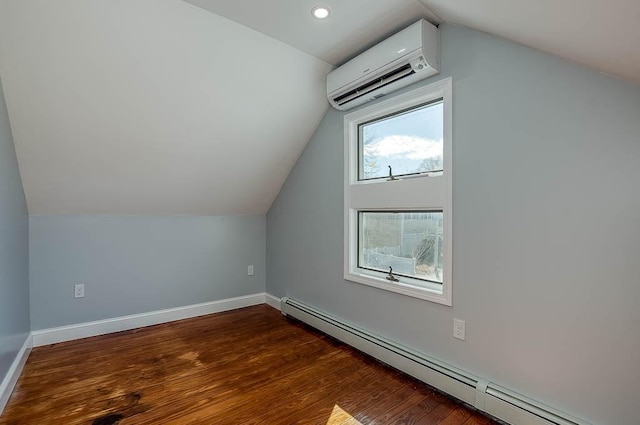 additional living space with lofted ceiling, a wall unit AC, dark wood-type flooring, baseboards, and baseboard heating