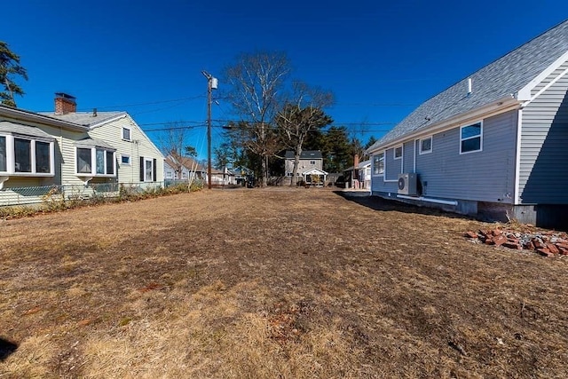 view of yard featuring ac unit and a residential view