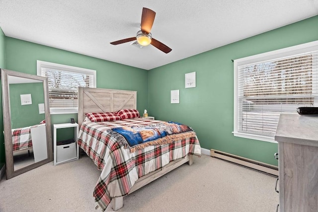 bedroom featuring ceiling fan, a textured ceiling, light carpet, and a baseboard heating unit