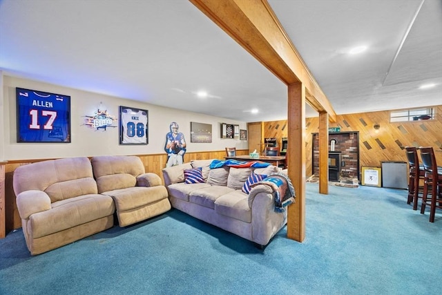 carpeted living room with wood walls