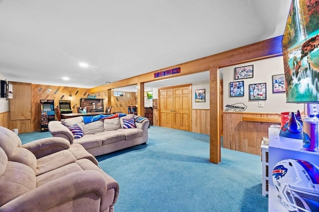 carpeted living room featuring wood walls