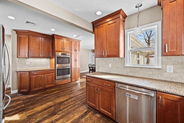 kitchen with stainless steel appliances, light stone countertops, decorative backsplash, dark hardwood / wood-style flooring, and decorative light fixtures