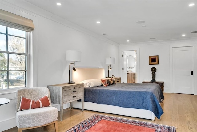 bedroom featuring light wood-style flooring, multiple windows, recessed lighting, and ornamental molding