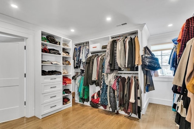 spacious closet featuring light wood-type flooring and visible vents