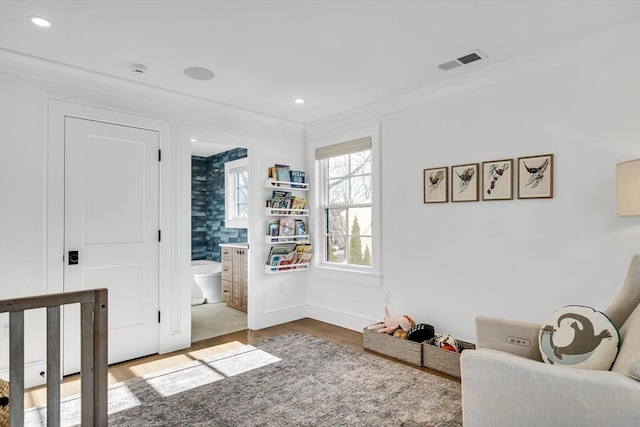 living area with recessed lighting, wood finished floors, visible vents, and baseboards