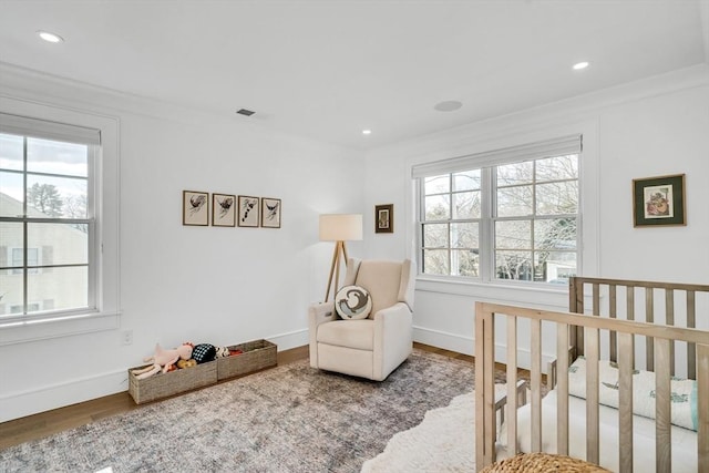 bedroom featuring recessed lighting, multiple windows, wood finished floors, and baseboards