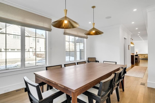 dining area with visible vents, recessed lighting, light wood-type flooring, and ornamental molding