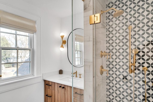 bathroom with a stall shower and vanity