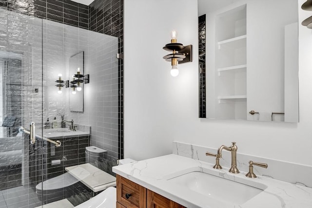 bathroom with vanity, toilet, a stall shower, and built in features